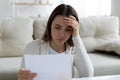 Woman holding letter read unpleasant news from friend or relative