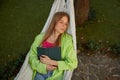 Woman relaxing with book falling asleep in hanging hammock Royalty Free Stock Photo