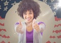 Millennial woman smiling and giving two thumbs up against hand drawn american flag with flare Royalty Free Stock Photo