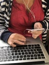 Millennial woman using a laptop computer and smartphone Royalty Free Stock Photo