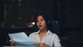 Millennial young Chinese businesswoman working late night stress out with project research problem on laptop in meeting room. Royalty Free Stock Photo