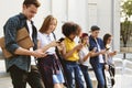 Millennials using smartphones outdoors together Royalty Free Stock Photo