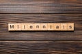 Millennials word written on wood block. millennials text on table, concept