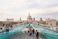 Millennium bridge with people walking in summer in London