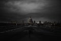 Millennium Bridge with the St Paul Cathedral in the distance below cloudy sky