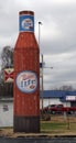 Miller light giant bottle and Budweiser beer sign