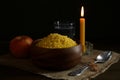 Millet, apple, water, burning candle and crucifix on wooden table. Great Lent season Royalty Free Stock Photo