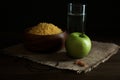 Millet, apple, water and crucifix on wooden table. Great Lent season Royalty Free Stock Photo