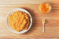 Millet boiled porridge with pumpkin in a plate on a wooden background. in the jar honey is open Royalty Free Stock Photo