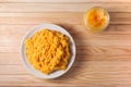 Millet boiled porridge with pumpkin in a plate on a wooden background. in the jar honey is open Royalty Free Stock Photo