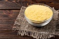 Millet flour on dark wooden.