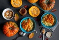 Millet porridge with pumpkin and honey in blue bowls, raw pumpkins and seeds, top view Royalty Free Stock Photo