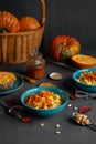 Millet porridge with pumpkin and honey served in blue bowls, raw pumpkins and seeds Royalty Free Stock Photo