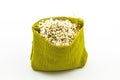 Millet rice in green sisal sack on white background Royalty Free Stock Photo