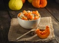 Millet, wheat and rice porridge with pumpkin, sprinkled with honey on a wooden background Royalty Free Stock Photo