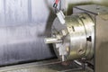 Milling detail on metal cutting cnc machine with raw metal tube