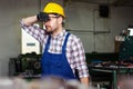 Milling machine operator working in factory workshop. Royalty Free Stock Photo