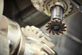 Cogwheel on shaft milling process. Industrial CNC metal machining by vertical mill