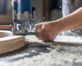 Milling wood in the joinery using manual mechanical cutters. Flying sawdust in the air