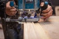 Milling a wooden part. A joiner processes a wooden product