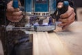 Milling a wooden part. A joiner processes a wooden product