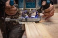 Milling a wooden part. A joiner processes a wooden product