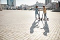 Million ideas for single journey. Friends using electric scooter on a sunny day Royalty Free Stock Photo