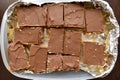 Millionaire`s shortbread or chocolate slices or chocolate caramel in a plastic box. Royalty Free Stock Photo