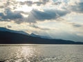 Millstaettersee - A pair of swans landing on Millstaetter lake in Austria during the sunset. The lake is surrounded by high Alps Royalty Free Stock Photo