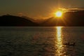 Millstaettersee - Two ducks crossing the Millstaetter lake in Austria during the sunset. The lake is surrounded by high Alps Royalty Free Stock Photo