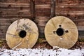 Millstones leaning against old wooden watermill Royalty Free Stock Photo