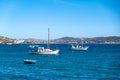 Milos Greek island, Cyclades. Fishing boat moored in open Aegean calm sea, blue sky background Royalty Free Stock Photo