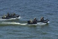 Miltary boats floating on water, armed soldiers of Special Forces aboard Royalty Free Stock Photo