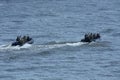 Miltary boats floating on water, armed soldiers of Special Forces aboard