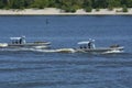 Miltary boats floating on the water, soldiers of Seaborne Special Forces aboard armed with machine guns.