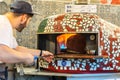 Milton Keynes,December 21,2018. Chef is putting gourmet freshly made pizza to the stone oven