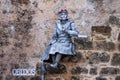 Mime actress interpreting a statue in the Portuguese village of Obidos.