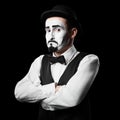 Mime artist shows sadness emotion. Isolated on black background.