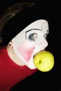 Mime biting an apple Royalty Free Stock Photo