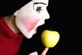 Mime biting an apple Royalty Free Stock Photo