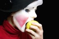 Mime biting an apple Royalty Free Stock Photo