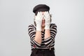 Mime caucasian woman covering her eyes waiting for surprise.