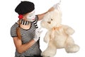 Mime comedian talking with teddy bear