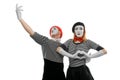 Mime couple in love. Surprised face of woman and man embracing her waist Royalty Free Stock Photo