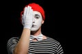 Mime covering half of face with hand Royalty Free Stock Photo