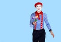 Mime with flower.Emotional funny actor wearing Royalty Free Stock Photo