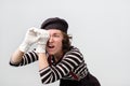 Mime looking through her fingers like binoculars, searching for something. Royalty Free Stock Photo