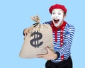 Mime with money bag.Emotional funny actor wearing