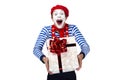 Mime with present.Emotional funny actor wearing Royalty Free Stock Photo