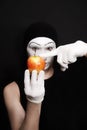 Mime with red apple on White gloves Royalty Free Stock Photo